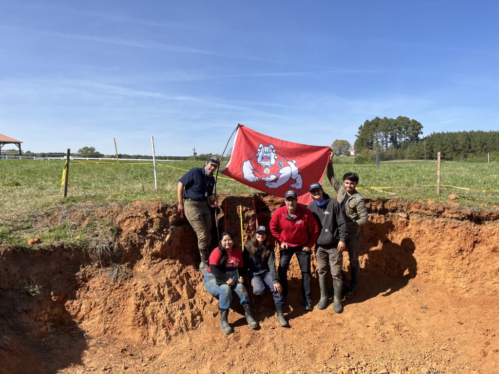 Fresno State soil judging team inside a pit in North Carolina.